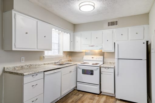 Affinitee at Pine Lake apartment a white kitchen with white appliances and white cabinets